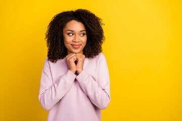 Photo of young lovely lady arms touch chin guess dream look empty space plan isolated over yellow color background