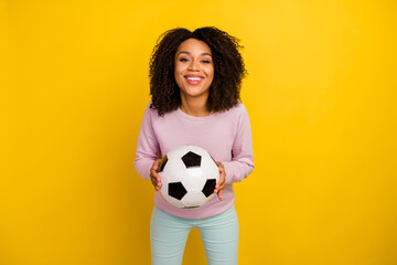 Photo of young cheerful lady catch throw ball competition game isolated over yellow color background