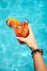 women's hands with a glass of cocktail