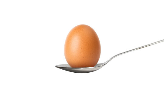 An egg in a spoon. World egg day. Food and breakfast concept.  Isolated on white background. - Powered by Adobe
