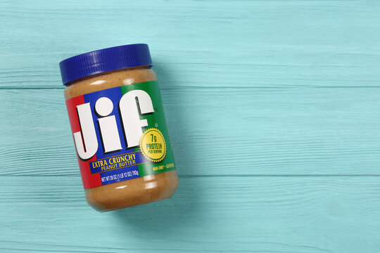 Jif peanut butter jar on a blue background, top view, flat lay with copy space