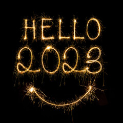 Happy New Year 2023. Sparkling burning text Happy New Year 2023 isolated on black background....