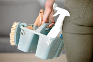 Cleaning tools, clean service and brush with hands holding basket with sponge and hygiene products....