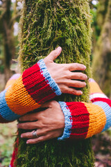People and nature. Human and environment concept. Close up of woman hugging with love a green tree...