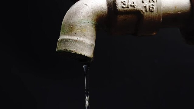 Leaking taps will be wasted in vain. touch with water drop Economical and wasteful concept