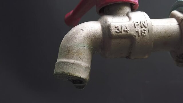 Leaking taps will be wasted in vain. touch with water drop Economical and wasteful concept