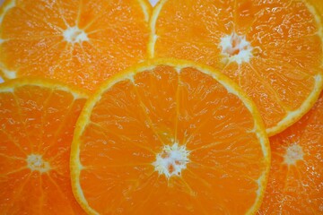 Slices round fresh orange texture background, concept mandarin, tangerine, wallpaper, vitamin c,...