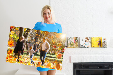Canvas print with gallery wrap. woman hangs autumn photography, photocanvas