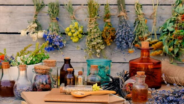 Tinctures and extracts of herbs in a jar. Selective focus.