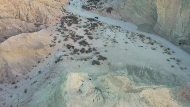 Overhead Aerial shot in 4k at Arroyo Tapiado Mud Caves in the Anza Borrego State Park as Cars Drive Through Shot