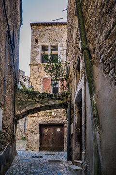 View on the narrow medieval street of Viviers old town in the South of France (Ardeche)