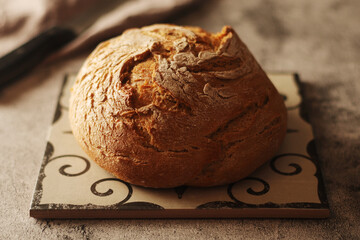A loaf of rye bread in low key