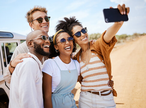 Safari, travel and friends phone selfie for social media with multiracial people on dirt road. Diverse friendship group enjoying bush holiday together in South Africa with smartphone photograph.