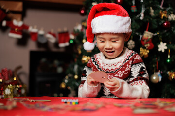Fototapeta na wymiar young girl making Christmas decorating card