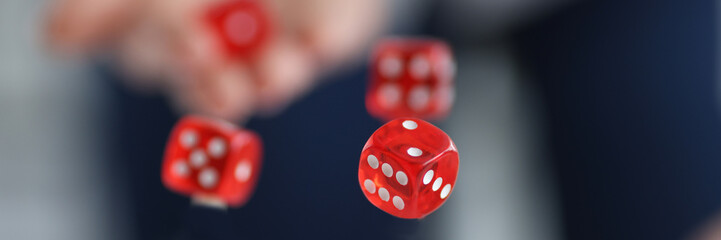 Red dice flying over casino chips closeup - obrazy, fototapety, plakaty
