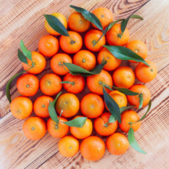 Mandarines in the middle of wooden background
