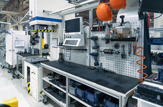 Workplace in modern industrial factory, interior and equipment.