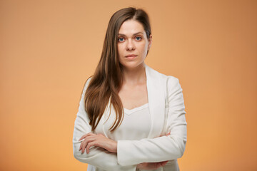 Obraz premium Confident business woman in white suit with arms crossed on yellow. Isolated female portrait.
