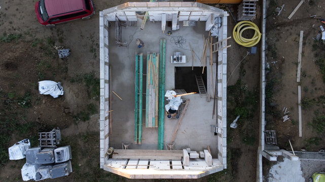 Drone photography of building a new house in a small willage under mountains at sunset