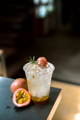 Cocktail with passion fruit in a plastic glass