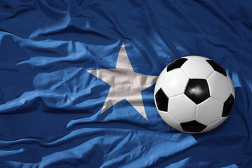 vintage football ball on the waveing national flag of somalia background. 3D illustration