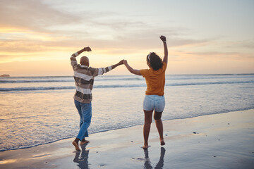 Love, travel and happy couple at beach enjoying summer vacation or fun honeymoon at sunset while...