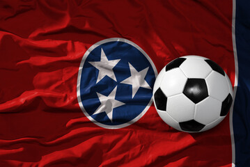 vintage football ball on the waveing tennessee state flag background. 3D illustration