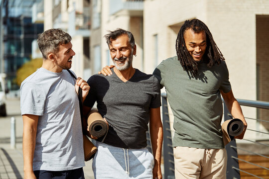 Smiling Group Of Men Walking Outside After A Gym Session