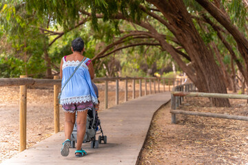 An elderly lady on the wooden footpath in the Lagunas de la Mata Natural Park in Torrevieja, Alicante