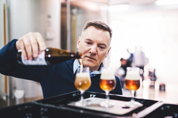 Man tasting craft beer from brewery.