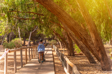 Sunset with an elderly lady with her grandson walking on the path of the Lagunas de la Mata Natural Park in Torrevieja, Alicante