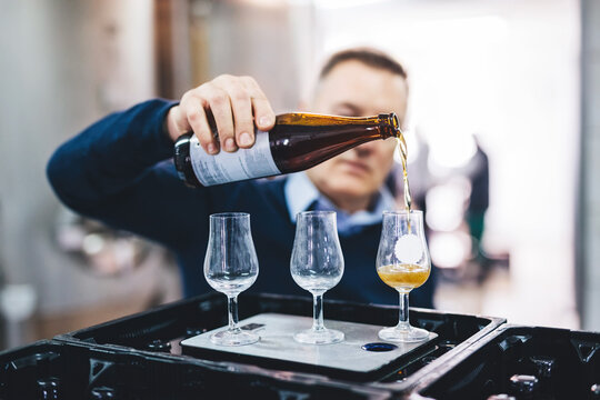 Man tasting craft beer from brewery.
