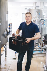 Brewery owner with crate of craft beer