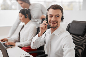 Happy help line worker looking at camera