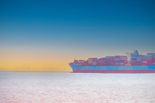 The sunset scene with  ship of  logistic and transportation as International  for import -export  oversea  business image