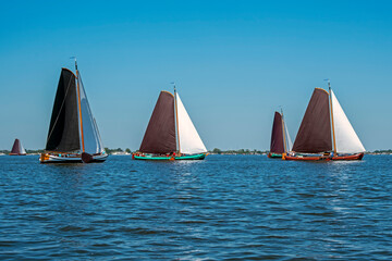 Naklejka premium Traditional Frisian wooden sailing ships in a yearly competition