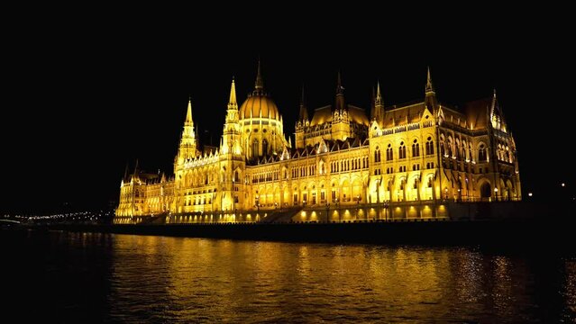 Hungarian parliament building in Budapest at night. seat of the Hungarian Parliament on the banks of the Danube in Budapest. Night Budapest in lights. Pleasure boat sails on the Danube in Budapest