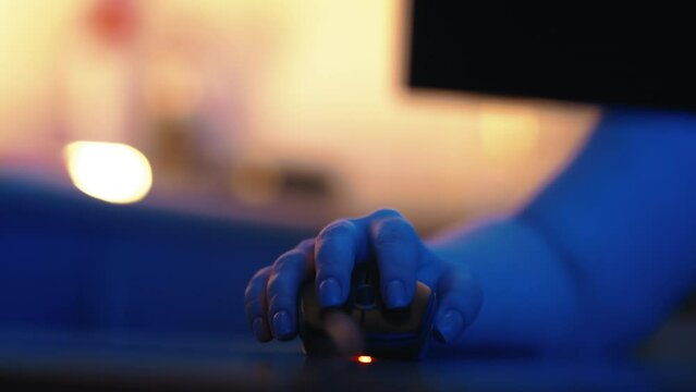 woman working online at home, freelancing, female hand working on a mouse close up