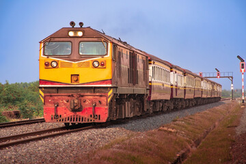 Obraz premium Passenger train by diesel locomotive at the railway station.