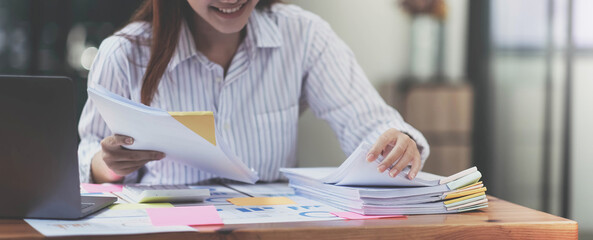 Business Documents concept : Employee woman hands working in Stacks paper files for searching and...