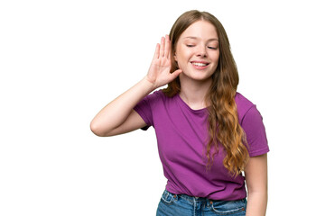 Fototapeta premium Young pretty woman over isolated background listening to something by putting hand on the ear