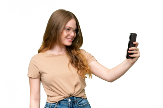 Young pretty woman over isolated background making a selfie