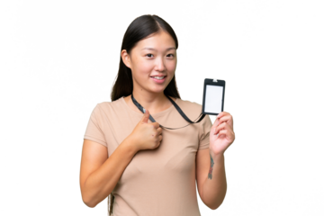 Young Asian woman with ID card over isolated background with thumbs up because something good has happened