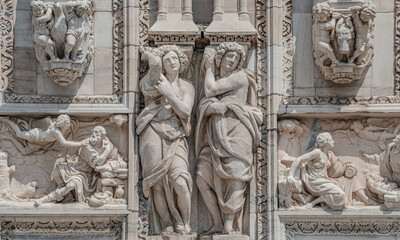 Two beautiful Roman women as decorative religious figures at facade of the Cathedral of Milano, Milan, Italy, closeup, details.