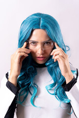 Futuristic concept, a young woman with blue hair, luminous glasses and a galactic suit, looking at the camera