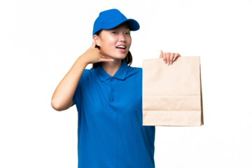 Young Asian woman taking a bag of takeaway food over isolated background making phone gesture. Call me back sign