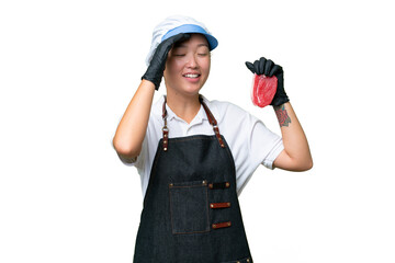 Young caucasian woman wearing an apron and serving fresh cut meat over isolated background smiling a lot