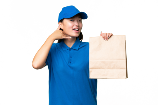 Young Asian woman taking a bag of takeaway food over isolated background making phone gesture. Call me back sign