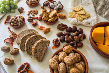 Table with a variation of autumn fruits. Background with fruit, nuts and pumpkin. All Saints Day.