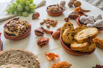 Table with a variation of autumn fruits. Background with fruit, nuts and pumpkin. All Saints Day.